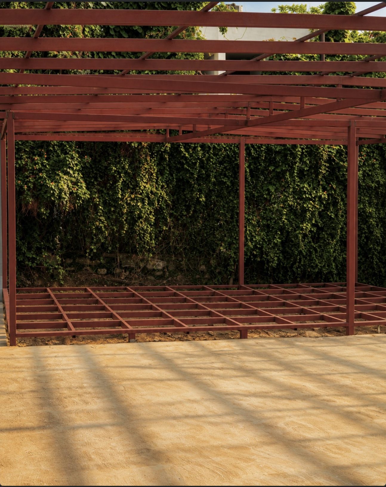 Steel pavilion against a living green wall where the Padel Fort café is coming up